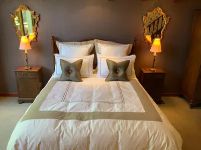 a white bed with two pillows and two lamps at Havenwood in Ayr