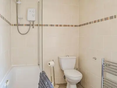 a bathroom with a toilet and a bath tub at Mullhill in Ardwell