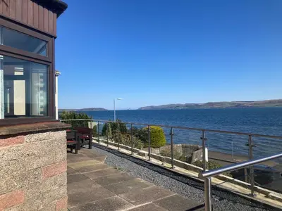 a house with a view of the water at Waters Edge in Stranraer