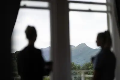 a couple of people standing in front of a window at Fellpack House in Keswick