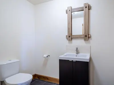 a bathroom with a toilet and a sink and a mirror at Seaviews And Hot Tub At Admirals Anchor in Portpatrick