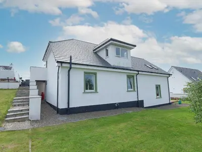 a white house with a grey roof at Seaviews And Hot Tub At Admirals Anchor in Portpatrick