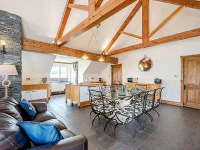 a kitchen and living room with a table and chairs at Seaviews And Hot Tub At Admirals Anchor in Portpatrick
