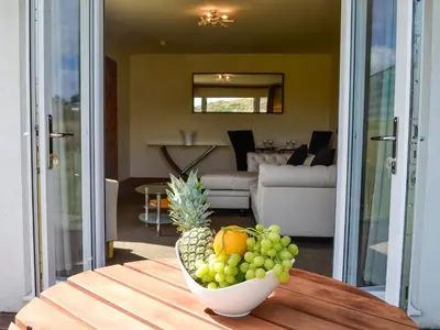 a bowl of fruit on a table in a living room at Seaviews And Hot Tub At The Fairways - Uk39821 in Portpatrick