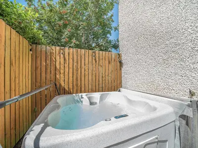 a bath tub sitting next to a wooden fence at 1 Ladyknowe - Uk39970 in Moffat