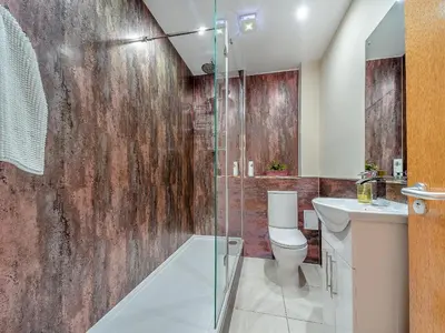 a bathroom with a toilet and a glass shower at 1 Ladyknowe - Uk39970 in Moffat