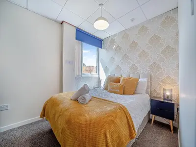 a bedroom with a bed with a yellow blanket on it at 1 Ladyknowe - Uk39970 in Moffat