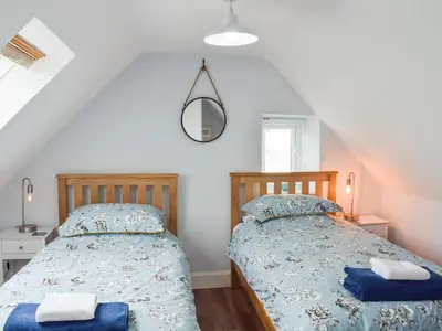 a bedroom with two beds in a attic at Seacliffe in Kildonan
