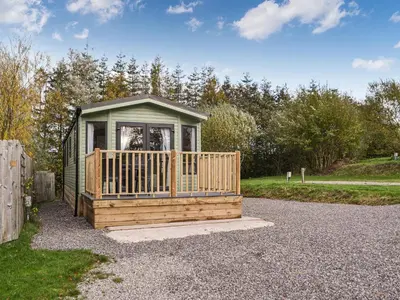 a small cabin with a porch on a gravel road at Willow - Uk36374 in Westward