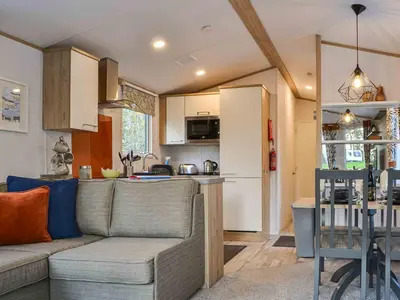 a living room with a couch and a kitchen at Willow - Uk36374 in Westward
