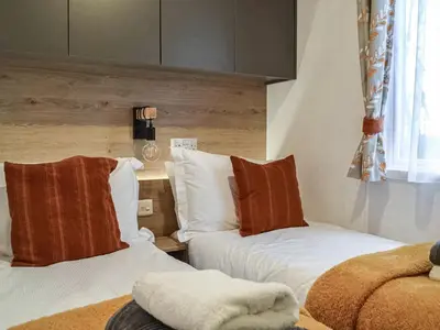 a bedroom with two beds with pillows on them at Willow - Uk36374 in Westward