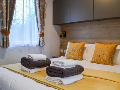 a bedroom with a bed with towels on it at Willow - Uk36374 in Westward