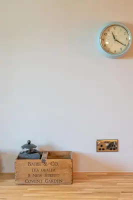 a clock sitting on top of a wooden table at Rose Cottage, Eden Valley, Cumbria in Cumwhitton