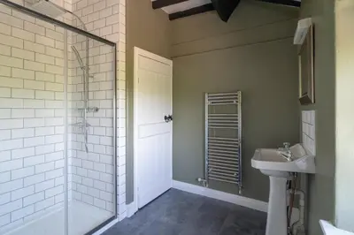 a bathroom with a shower and a sink at Rose Cottage, Eden Valley, Cumbria in Cumwhitton