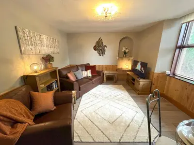 a living room with a couch and a tv at Beautiful Apartment - Outstanding Central Location - Pass the Keys in Dumfries