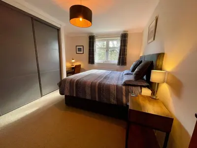 a bedroom with a bed and a window at Turnberry Apartment - Ailsa Gem in Turnberry