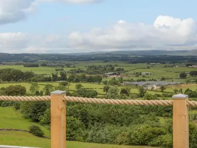 a view of the rolling hills from the porch of a house at Laird Lodge 4 in Lockerbie
