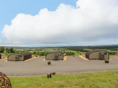 a group of three domes on a gravel field at Laird Lodge 4 in Lockerbie
