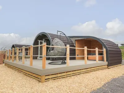 a dome house with a deck and a fence at Laird Lodge 5 in Lockerbie