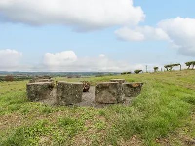 two concrete tanks sitting on top of a grassy field at Laird Lodge 5 in Lockerbie