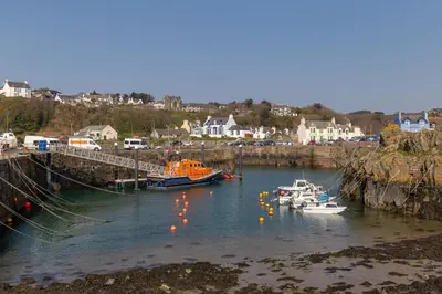a group of boats are docked in a harbor at The Knowe in Portpatrick