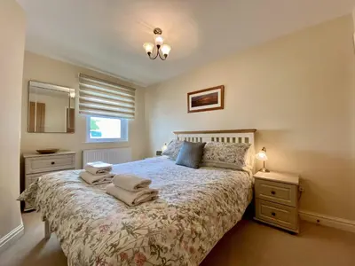 a bedroom with a bed with towels on it at 8 Howrahs Court, Keswick in Keswick