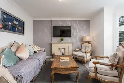 a living room with a couch and a table at 9A Millbrae - Donnini Apartments in Ayr