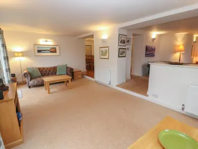 a living room with a couch and a table at Huntingstile Lodge in Ambleside