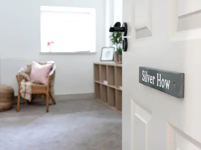 a room with a door with a sign that reads super how at Thorney How in Ambleside