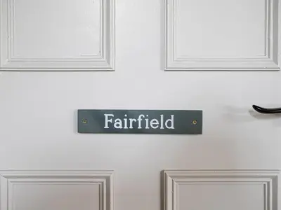 a sign on a door with the word painted on it at Thorney How in Ambleside