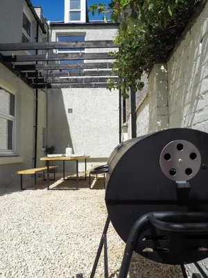 a black chair sitting in front of a patio at Coorie Away - Kirkcudbright in Kirkcudbright