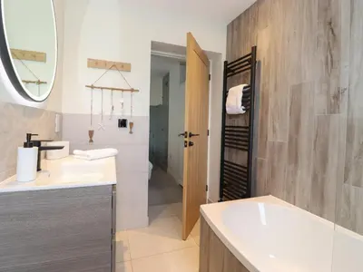 a bathroom with a white sink and a mirror at Fran's Nest in Keswick
