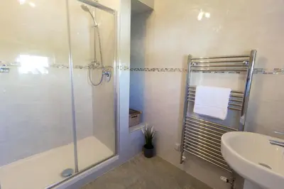 a bathroom with a shower and a sink at Arran View Apartment at Heads of Ayr in Ayr
