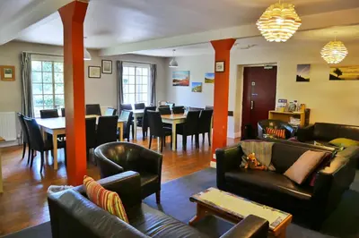 a living room with couches and a dining room at Elterwater Hostel in Elterwater