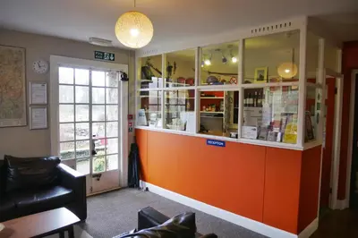 a shop with an orange counter in a room at Elterwater Hostel in Elterwater