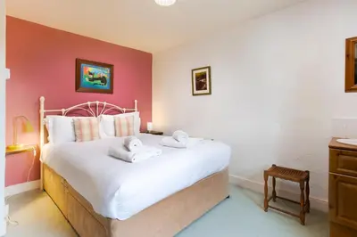 a bedroom with a large bed with towels on it at Old Sawpit in Ambleside
