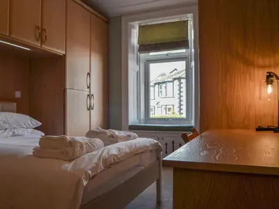 a bedroom with a bed and a window at 4 Harney Peak in Portinscale