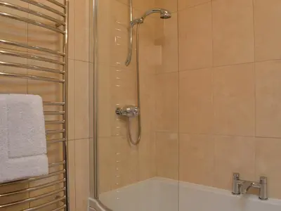 a bathroom with a shower and a bath tub at 4 Harney Peak in Portinscale