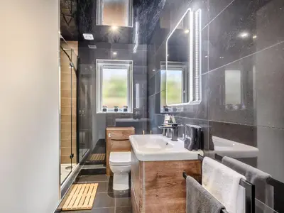 a bathroom with a white sink and a toilet at Appletree Lodge in Ayr