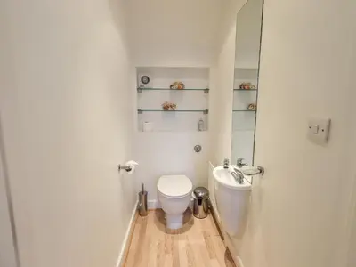 a small bathroom with a toilet and a sink at Fell Sweep in Keswick