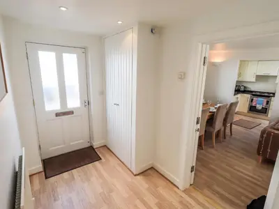 a living room with a door leading to a kitchen at Fell Sweep in Keswick