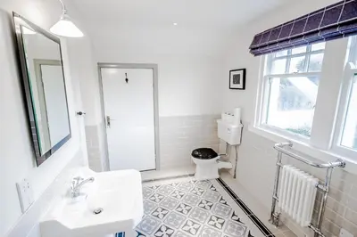 a white bathroom with a sink and a toilet at Diamonds Laggan in Castle Douglas
