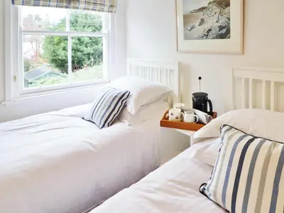 two beds in a bedroom with a window at Union Street in Kirkcudbright
