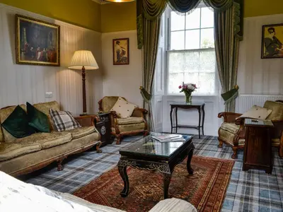 a living room with a couch and chairs and a table at Craigvar House in Castle Douglas