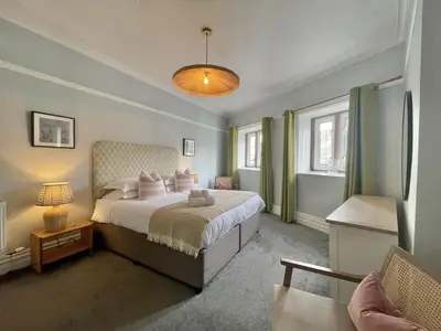 a bedroom with a large bed and a window at Grandy Nook in Keswick