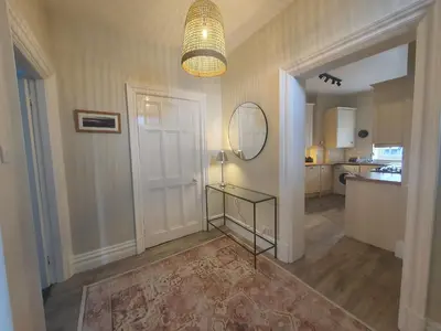 a room with a hallway with a mirror and a door at Grandy Nook in Keswick
