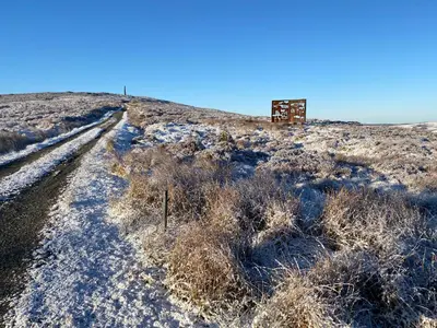 a snow covered hill with a structure on top of it at Stables Cottage in Langholm