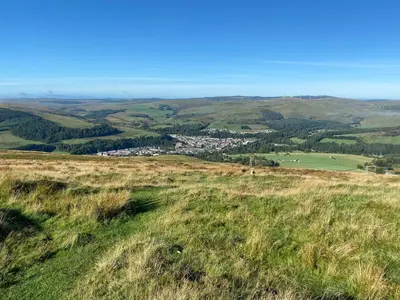 a view from the top of a grassy hill at Stables Cottage in Langholm