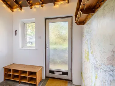 a room with a door and a map on the wall at 1, The Barns in Threlkeld