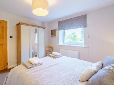 a bedroom with a bed with two towels on it at 1, The Barns in Threlkeld